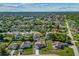Aerial view of a home showing its position on a lot, fence, landscaping, nearby homes and surrounding neighborhood at 3256 Amber St, Deltona, FL 32738