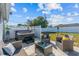 Backyard patio with a hot tub, comfortable seating, and a privacy fence, perfect for relaxation and entertaining at 3256 Amber St, Deltona, FL 32738