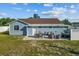 Backyard patio featuring outdoor seating, hot tub, and well-maintained fencing creating a cozy retreat at 3256 Amber St, Deltona, FL 32738