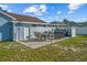 This backyard is perfect for outdoor entertaining, featuring a patio with a dining set and lounge furniture at 3256 Amber St, Deltona, FL 32738