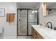 Modern bathroom featuring a marble-walled shower with a sleek black frame and a vanity with a marble countertop at 3256 Amber St, Deltona, FL 32738