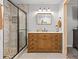 Bathroom with a glass shower, a spacious wooden vanity with drawers, and modern lighting for a spa-like experience at 3256 Amber St, Deltona, FL 32738