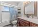 Inviting bathroom featuring a combination shower and tub, wood-look flooring, and a vanity with a stylish countertop at 3256 Amber St, Deltona, FL 32738