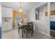 A dining room features a gray table set with seating for four, under a modern light fixture at 3256 Amber St, Deltona, FL 32738