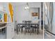 A dining room features a gray table set with seating for four, under a modern light fixture at 3256 Amber St, Deltona, FL 32738