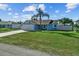 Beautiful single-story home with green lawn, features palm tree and a long driveway at 3256 Amber St, Deltona, FL 32738