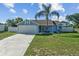 Inviting one-story home with an attached two-car garage, well-kept lawn, and driveway at 3256 Amber St, Deltona, FL 32738