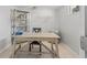 Bright office space with neutral walls, a desk, chair, and a stylish bookcase for a functional and organized work area at 3256 Amber St, Deltona, FL 32738