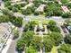 Aerial view of a community gazebo surrounded by lush greenery near condos and a parking area at 3280 Soho St # 306, Orlando, FL 32835
