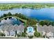 Beautiful aerial view of townhomes, lake, and pool in a serene community setting at 3280 Soho St # 306, Orlando, FL 32835