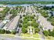 Aerial view of a large planned community features townhomes, mature trees, pool, and lake views at 3280 Soho St # 306, Orlando, FL 32835