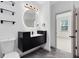 Stylish bathroom with a modern vanity, sleek black fixtures, and an illuminated round mirror at 3280 Soho St # 306, Orlando, FL 32835