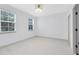 Bright bedroom with neutral walls, wood-look floors, two windows, and modern lighting at 3280 Soho St # 306, Orlando, FL 32835