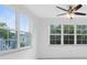 Bright bedroom with large windows offering scenic views and a ceiling fan at 3280 Soho St # 306, Orlando, FL 32835