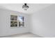 Empty bedroom with a window overlooking the backyard and a modern ceiling light at 3280 Soho St # 306, Orlando, FL 32835