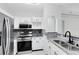 Modern kitchen with stainless steel appliances, stone countertops, and ample cabinet space at 3280 Soho St # 306, Orlando, FL 32835