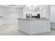 Bright kitchen with a breakfast bar, stainless steel appliances, and modern lighting at 3280 Soho St # 306, Orlando, FL 32835