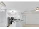 Open-concept kitchen flowing into living space, featuring modern appliances and breakfast bar at 3280 Soho St # 306, Orlando, FL 32835