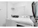 A well-equipped laundry room contains a full-size washer, dryer, and overhead shelving at 3280 Soho St # 306, Orlando, FL 32835