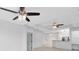 Open-concept living room with modern ceiling fans and a breakfast bar leading to the kitchen at 3280 Soho St # 306, Orlando, FL 32835