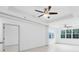 Spacious living room with tray ceilings, ceiling fans and large windows providing ample natural light at 3280 Soho St # 306, Orlando, FL 32835