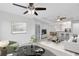 Open-concept living room with modern furniture and a seamless flow into dining area at 3280 Soho St # 306, Orlando, FL 32835