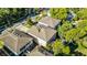 Aerial view showing backyard area with patio and nearby lush greenery, adjacent to neighboring houses at 336 E Kaley St, Orlando, FL 32806