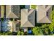 Aerial view of a home showcasing roof details, backyard and patio area, with mature surrounding trees at 336 E Kaley St, Orlando, FL 32806