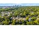 Aerial view of the neighborhood with the skyline in the distance, surrounded by lush trees at 336 E Kaley St, Orlando, FL 32806