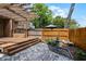 Backyard features brick pavers, a wooden deck, a fountain, and a wooden fence at 336 E Kaley St, Orlando, FL 32806