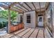 Backyard features brick pavers, a wooden deck, an outdoor grill, and a pergola at 336 E Kaley St, Orlando, FL 32806