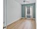 This bright bedroom has hardwood floors, neutral paint, large window, and a ceiling fan at 336 E Kaley St, Orlando, FL 32806