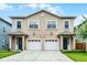 Inviting exterior of a two-story townhome with a neutral color scheme and a two-car garage at 336 E Kaley St, Orlando, FL 32806