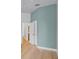 Hallway with light hardwood floors, light paint, and doors to bathroom and bedroom at 336 E Kaley St, Orlando, FL 32806