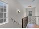 Bright upper-level landing with window, chandelier, and decorative railing overlooking the staircase at 336 E Kaley St, Orlando, FL 32806
