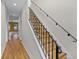 Elegant staircase with decorative iron railing and hardwood steps leading to the upper level at 336 E Kaley St, Orlando, FL 32806