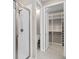 Bright bathroom featuring a glass shower, toilet and large walk-in closet with shelving at 3990 Bannock Ave, Tavares, FL 32778