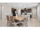 Bright dining area featuring stylish table, seating for six and modern pendant lighting at 3990 Bannock Ave, Tavares, FL 32778