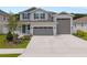 Charming two-story home with three-car garage, landscaped yard and covered entryway at 3990 Bannock Ave, Tavares, FL 32778