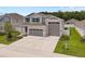 Charming two-story home with a three-car garage, landscaped yard, and inviting curb appeal at 3990 Bannock Ave, Tavares, FL 32778