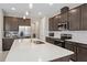 Modern kitchen with stainless steel appliances, a center island, and dark wood cabinetry at 3990 Bannock Ave, Tavares, FL 32778
