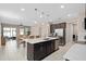 Open kitchen with stainless steel appliances, large island, and adjacent dining area at 3990 Bannock Ave, Tavares, FL 32778