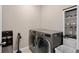 Modern laundry room with front loading washer and dryer, plus utility sink at 3990 Bannock Ave, Tavares, FL 32778