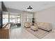 Cozy living room with sliding doors leading to a screened patio and a neutral color palette at 3990 Bannock Ave, Tavares, FL 32778