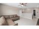 Relaxing living area with neutral tones and a comfortable sectional sofa with tile floors at 3990 Bannock Ave, Tavares, FL 32778