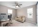 Home office featuring a cozy couch, desk, chair, and natural light streaming in through two windows at 3990 Bannock Ave, Tavares, FL 32778