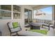 Cozy screened porch with ample seating and a view of the backyard at 3990 Bannock Ave, Tavares, FL 32778