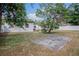 Backyard featuring a concrete patio and a spacious grassy area, bordered by a white privacy fence at 4420 Lake Lawne Ave, Orlando, FL 32808