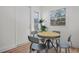 Charming breakfast nook with a round table, four chairs, and natural light from two windows at 4420 Lake Lawne Ave, Orlando, FL 32808