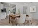 Bright dining room featuring modern decor, wood table set for a meal and wood floor at 4420 Lake Lawne Ave, Orlando, FL 32808